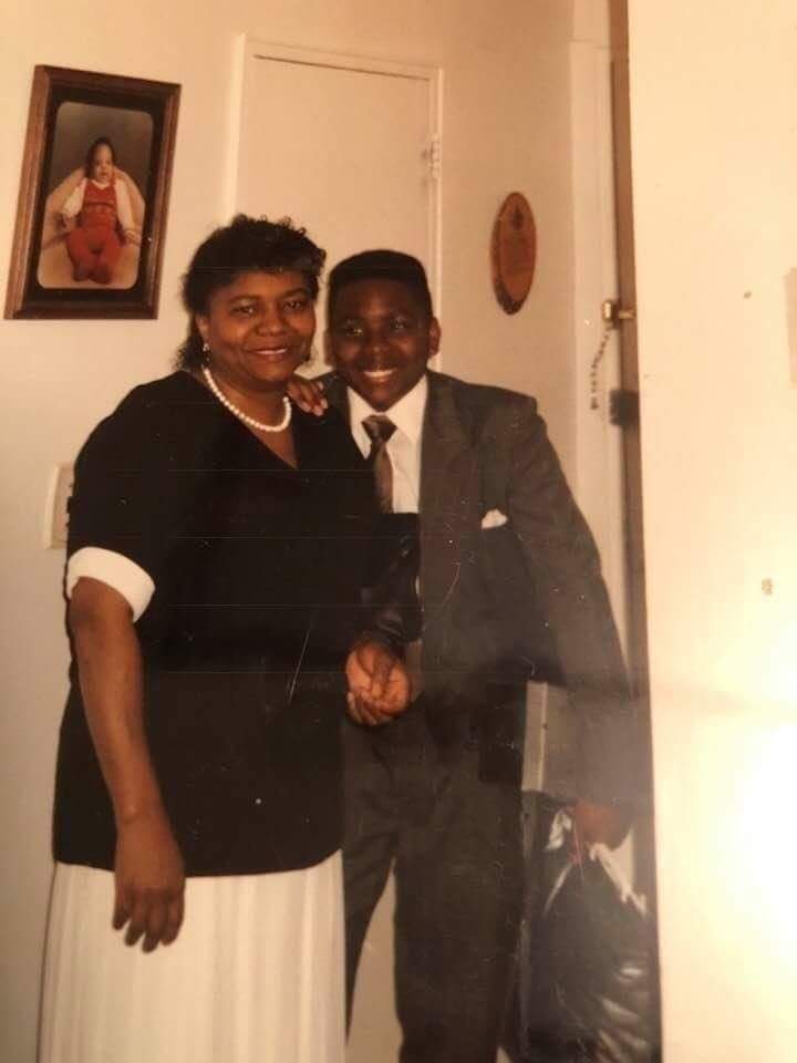 A picture of the OP in a suit with his mother. 